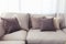Beige cushion on grey sofa