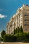 Beige Facade of a luxury residential building with stained glass Windows and columns.