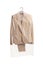 Beige female suit on a hanger with a plastic dry cleaning bag