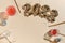 beige festive background with pink drinks and foil gold balloons in the shape of number 2022