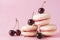 Beige French macaroons with cherries with pink cream on a pink background, cookies