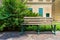 Beige garden bench  at public park at summer time