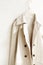 Beige or greige elegant trench coat isolated over white