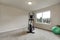 Beige interior of small home gym with sport equipment