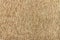 Beige knitted textured background with a pattern closeup