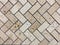 Beige or light brown colors Stone wall texture.Wall pattern or abstract background. Herringbone pattern.