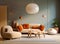 Beige lounge chair near curved sofa with orange vibrant cushions and big ball pendant light. Minimalist home interior design of