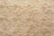 Beige natural wool with twists texture background. Cotton wool, white fleece carpet. White fur rug with pattern