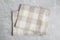 Beige plaid kitchen  on light marble background, top view