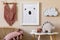 Beige playroom for kids with cute natural animal toys and poster in cosy Scandinavian style.