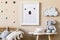 Beige playroom for kids with cute natural animal toys and poster in cosy Scandinavian style.