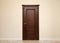 Beige room interior with brown wooden door