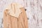 Beige sheepskin coat on a wooden background. Fashionable concept