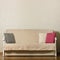 Beige sofa with colorful pillows pink, grey, white in the livi