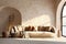 Beige sofa with cushions and plaid against of arched window and stone stucco wall. Farmhouse boho interior design of modern living