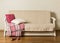 Beige sofa with plaid and colorful pillows pink, grey, white i