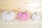 beige and soft pink colored crochet woolen pumpkins on wooden ground