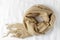 Beige soft scarf made of fine pure cashmere with tassels on a linen