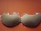 Beige strapless bra close-up on different color backgrounds, size A.
