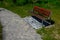 Beige threshing path gravel with delimited edges granite cubes in a row and dividing channels from the cube trough channel due to