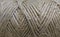 Beige twine rope in a coil. thread twine roll texture background