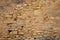 Beige wall pebble stones old weathered handcrafted stone wall background