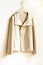 Beige or white jacket hanging on clothes hanger on white background