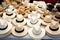 Beige and white straw hats in a row
