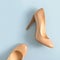 Beige women high heel shoes on pink background. Fashion blog look.