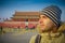 BEIJING, CHINA - 29 JANUARY, 2017: Hispanic tourist on Tianmen square looking around, famous forbidden city building in