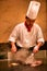 Beijing, China - June 9, 2018: A Chinese chef is cooking dinner in front of the restaurant visitors.