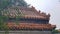 Beijing-A close up on the rooftop of a pavilion in Forbidden City in China. The roof has orange tiles and decorative small figures