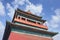 Beijing drum tower against a blue sky with dramatic clouds