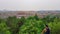 Beijing - A man in full cap standing at the viewing platform in Jingshan Park with the panoramic view on  Forbidden City