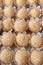 Beijinho de Coco - Traditional Brazilian candy called Coconuts Little Kiss with paper cups. Vertical shot. Close-up