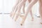 Being a dancer takes commitment. a group of ballerina dancers practicing a routine in their pointe shoes.