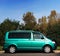 Belarus, Brest - August 04, 2019: Volkswagen T 5 Transporter  green passenger van back view. Photographing a modern car in the par