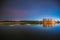 Belarus, Eastern Europe. Night Sky Stars Above Countryside Landscape With River. Natural Starry Sky Above Lake Pond In