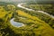 Belarus. Elevated View Of Small Bog Marsh Swamp Wetland, River And Green Forest Landscape In Sunny Summer Day. Attitude