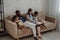 Belarus and Hispanic couple with their doughters on sofa