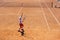 Belarus, Minsk 26.05.18. The boy plays tennis on the orange dirt court. Court hard