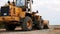 Belarus, Minsk - October 8, 2021: Tractor bulldozer drives close-up. Front-end loader using bucket. Road construction. Large