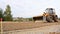 Belarus, Minsk - October 8, 2021: Tractor bulldozer drives close-up. Front-end loader using bucket. Road construction. Large