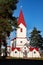 BELARUS, NOVOPOLOTSK - OKTOBER 16, 2019: Red roof of church with cross among trees