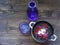 Belarussian and russian national vegetable soup - red borsch on wooden brown table with violet glass, view with copy space