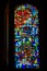 BELFAST, NORTHERN IRELAND, DECEMBER 19, 2018 Detail of a colorful stained glass window from inside of church, reflecting colors in