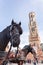 Belfort tower in Bruges at the Market Square with horses, Belgium.