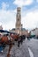 Belfort tower in Bruges at the Market Square with horses, Belgium.