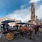 Belfort tower in Bruges at the Market Square with horses, Belgium.