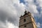 Belfry on the background of a cloudy blue sky.